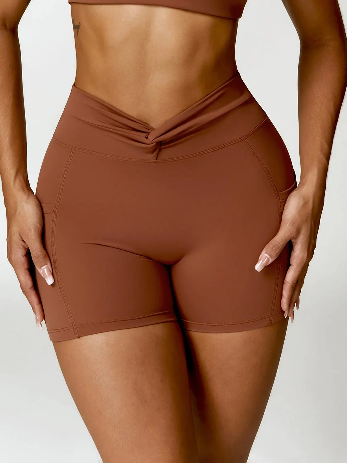 Twisted High Waist Active Shorts with Pockets Trendsi